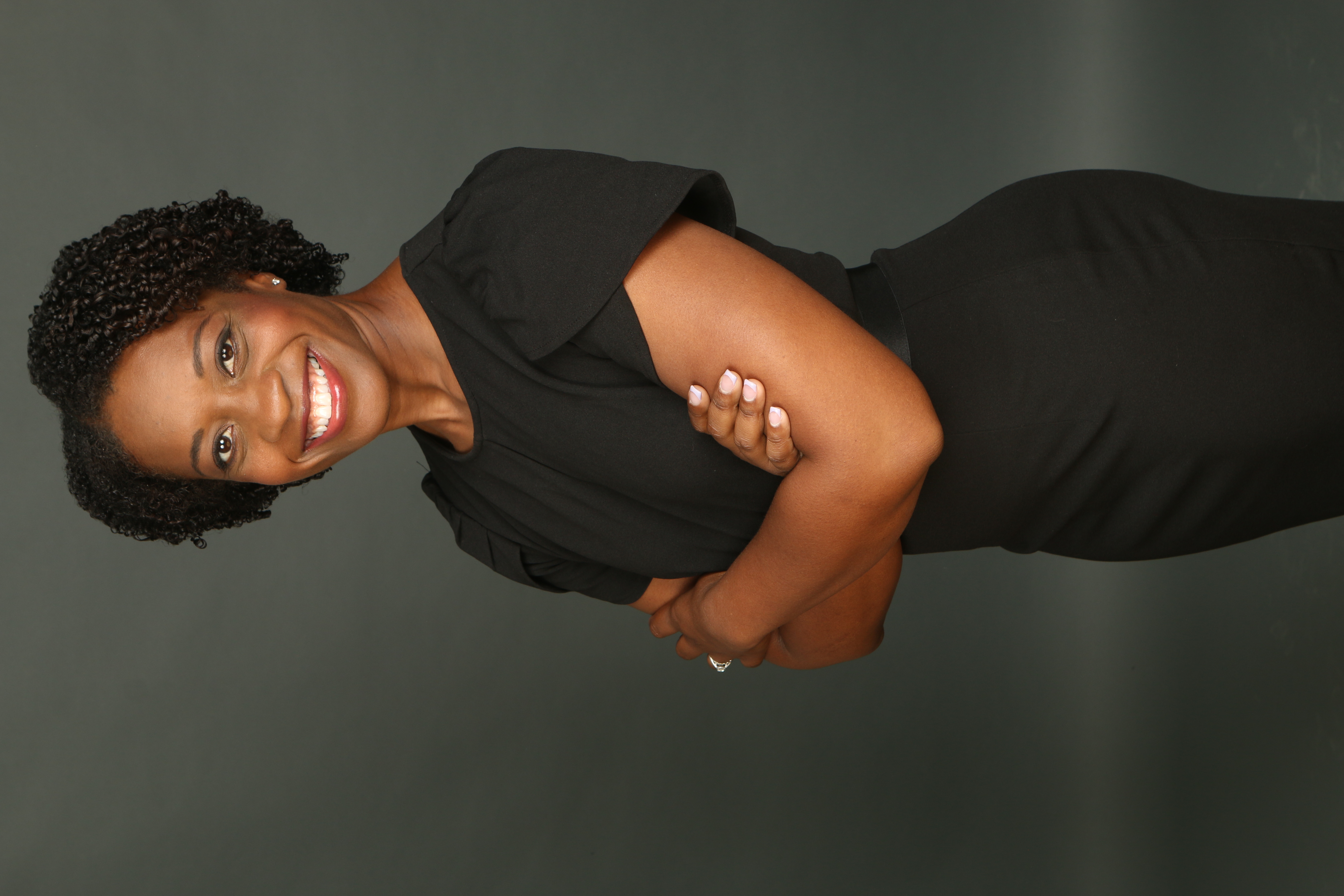 Toni McFadden smiling with her arms folded